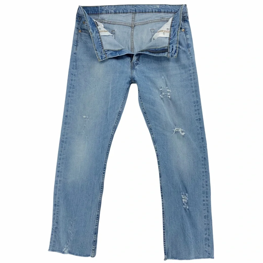 Levi’s 513 Slim Straight Distressed Light Wash Jeans